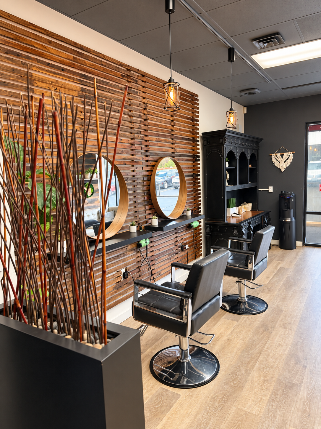 Hollywood 2U styling stations with warm wood walls and round mirrors